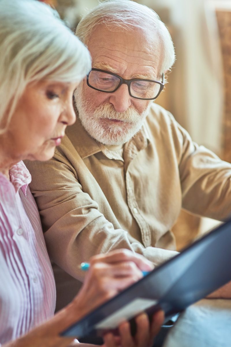 Elderly man and woman checking internal finances